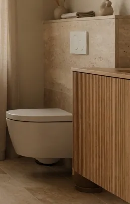 Fluted timber vanity unit beside a wall-hung WC