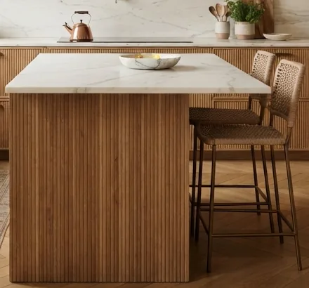 Kitchen island with a fluted oak front and a marble top